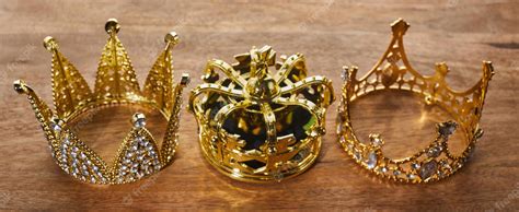 Premium Photo | Happy Epiphany day Three gold crowns on wooden ...