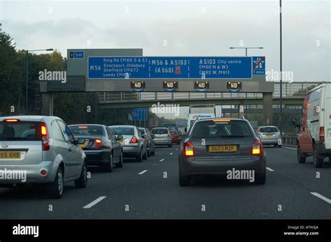 CARS WITH FLASHING HAZARD WARNING LIGHTS IN TRAFFIC QUEUE ON M56 Stock ...