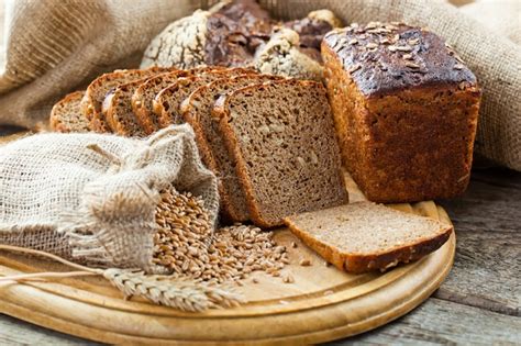 Premium Photo | Bread and wheat on a wooden background