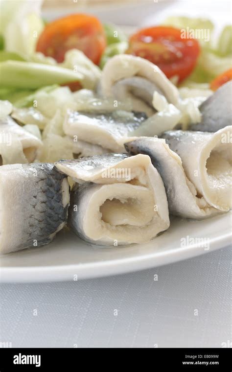 Rollmops or pickled herring fillets served with salad a popular seafood ...