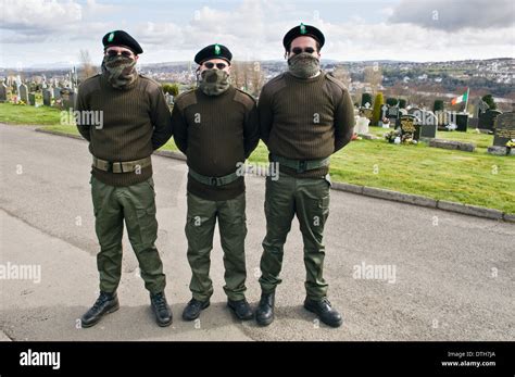 Three men dressed in IRA paramilitary uniforms at Derry Cemetery Stock ...