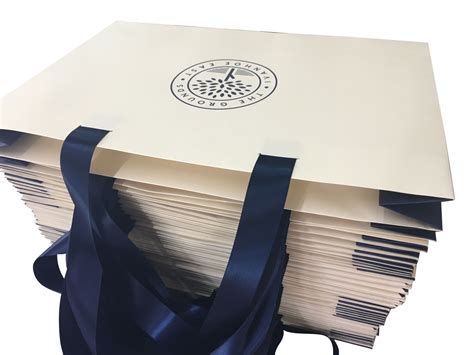 a stack of white envelopes with blue ribbon tied around the edges and ...