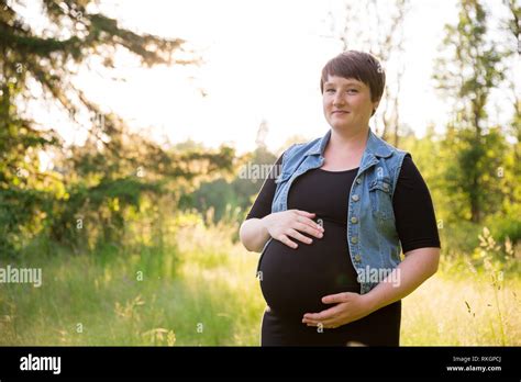 Maternity photo of a young woman with a short hair pixie cut in her ...