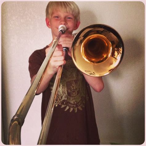 My baby is learning the trombone this year. He looks so ti… | Flickr