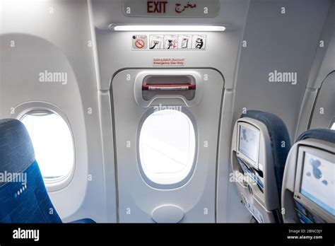 Emergency exit door in an airplane Stock Photo - Alamy