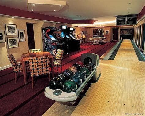 A huge basement with a pool table, arcade games and a bowling alley ...