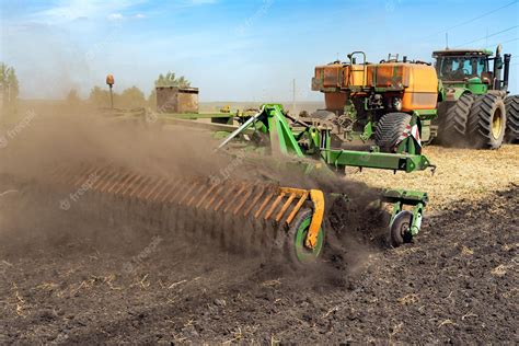 Premium Photo | The tractor plows the land agriculture image