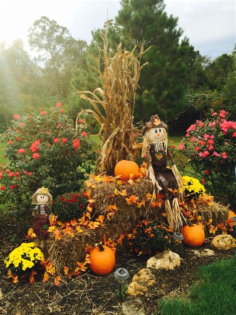 Fall display at driveway entrance with mums, pumpkins, corn stalks, hay ...