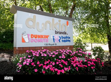 A logo sign outside of the headquarters of Dunkin' Brands Group, Inc ...