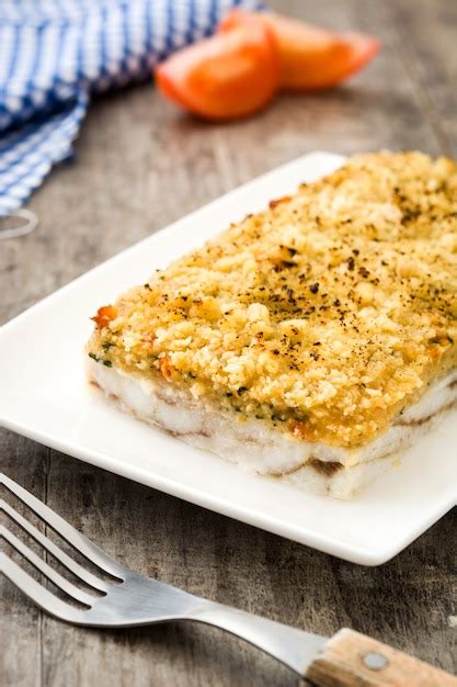 Premium Photo | White fish casserole with cheese on wooden.