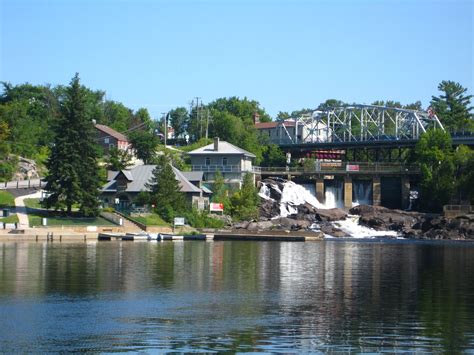 a river with houses and bridge in the background