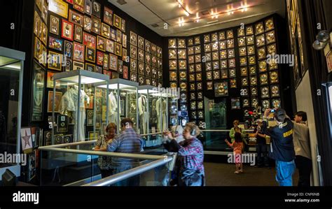 Visitors at the Elvis Presley museum at Graceland with gold records and ...