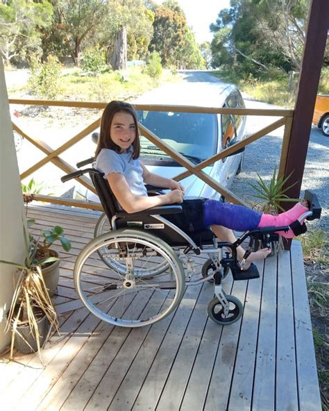 a woman in a wheel chair on a porch