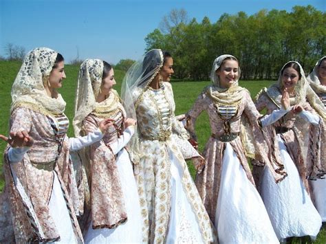 A group of young women sporting beautiful, pale hued traditional ...