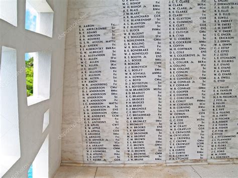 Names on the wall of the USS Arizona Memorial beside a unique window ...