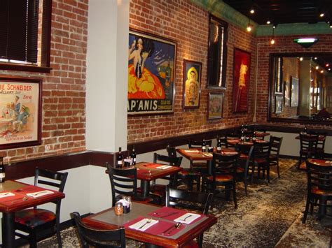 the interior of a restaurant with tables and chairs