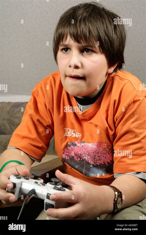 portrait of a young boy playing playstation Stock Photo - Alamy