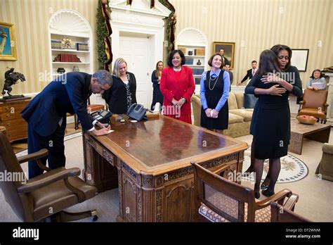 US President Barack Obama signs items at the Resolute Desk after he and ...