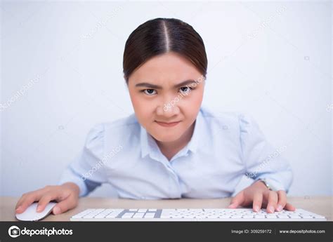 Angry woman use computer look at the camera on isolated backgrou Stock ...