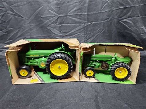 (2)-1/16th Ertl John Deere Wide Front Tractors - Aumann Auctions, Inc.