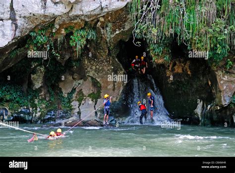 Tourists crossing Rio Claro River from a cave, Rio Claro Nature Reserve ...