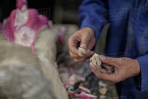 Cropped view of sculptor in artist studio creating plaster cast ...