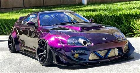 a purple and black car parked on the street