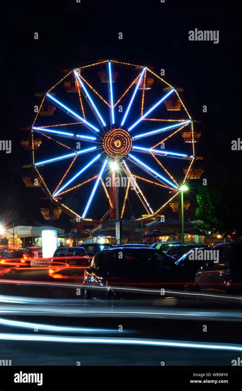 Night view of a Ferris wheel and car trails Stock Photo - Alamy