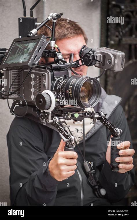 Behind the scene. Cameraman shooting the film scene with his camera on ...