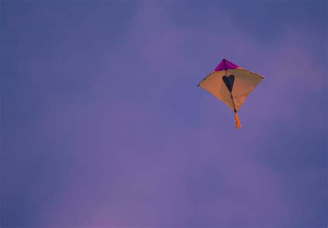 yellow and purple kite in the sky 25880258 Stock Photo at Vecteezy