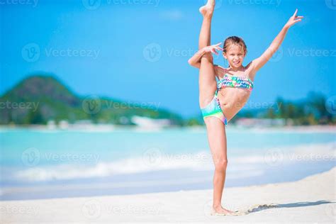 Beautiful little girl on beach having fun. Happy girl enjoy summer ...