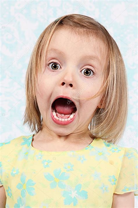 Adorable little girl making funny faces in studio Stock Photo by ...