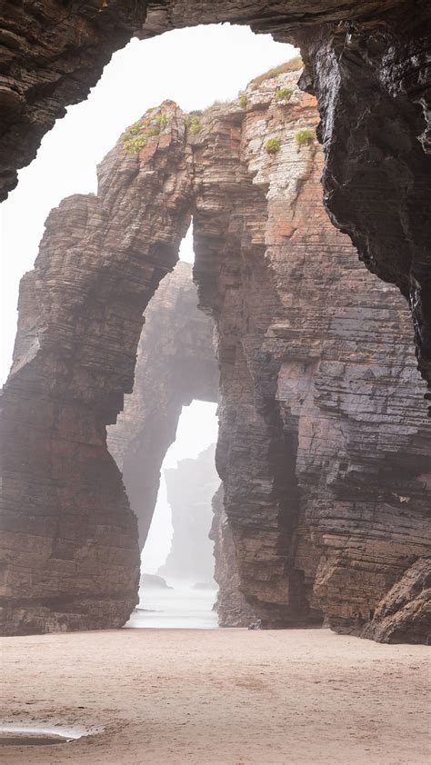 Natural rock arches on Cathedrals beach in low tide, Praia As Catedrais ...