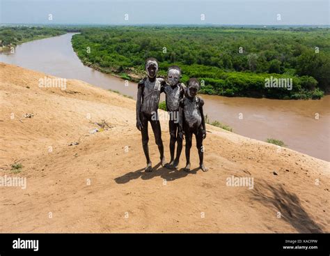 Karo tribe kids standing in front of Omo river, Omo valley, Korcho ...