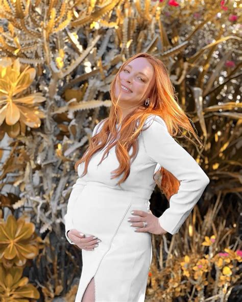 Pregnant Lindsay Lohan cradles bump in glowing baby shower pics