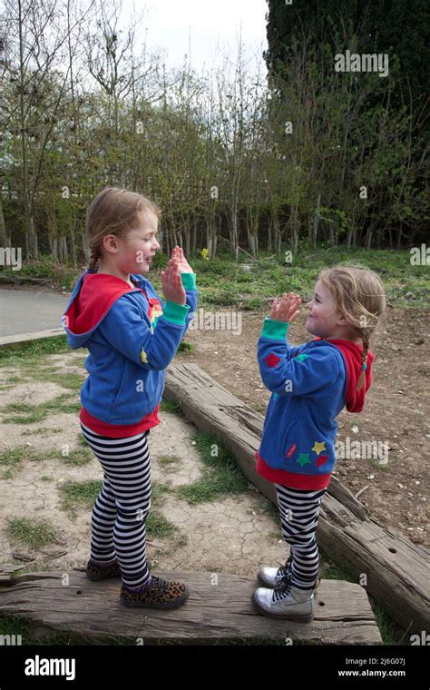 Kids playing Pat a Cake game, UK Stock Photo - Alamy