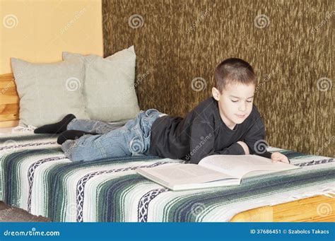 Boy reading on bed stock image. Image of young, reading - 37686451