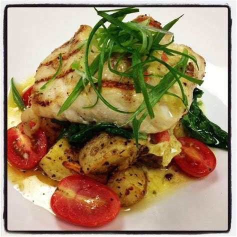 Grilled corvina with herb and garlic roasted Yukon potatoes, spinach ...