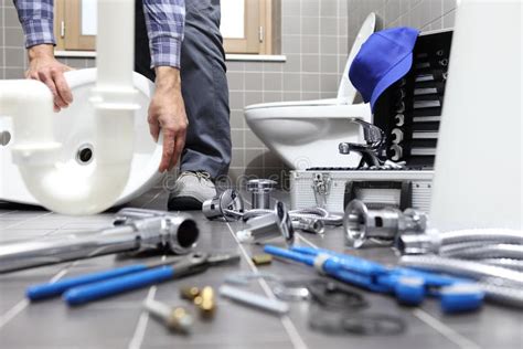 Plumber at Work in a Bathroom, Plumbing Repair Service, Assemble Stock ...