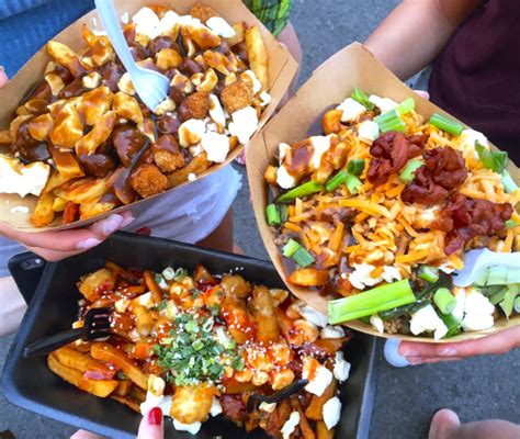 three people are holding up some food in their hands