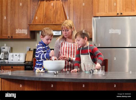 Mom and young boy's cooking together in kitchen Stock Photo - Alamy