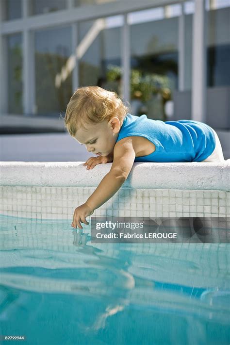 Baby Boy Playing With Water High-Res Stock Photo - Getty Images