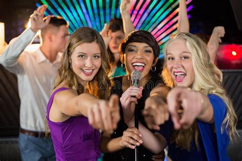 Female Friends Singing Song Together in Bar Stock Image - Image of ...