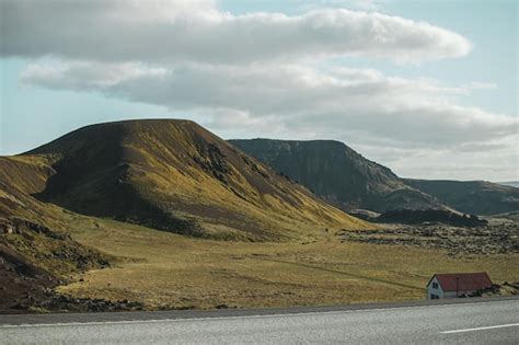 Premium Photo | A car on the road with mountains in the background