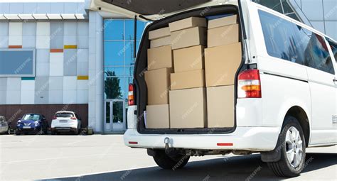 Premium Photo | A white delivery service car with boxes inside