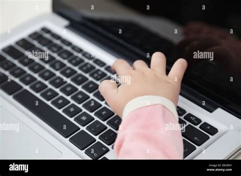 Girl's Hand Typing On Laptop Keyboard Stock Photo - Alamy