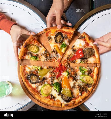 Taking pizza slices top view Stock Photo - Alamy