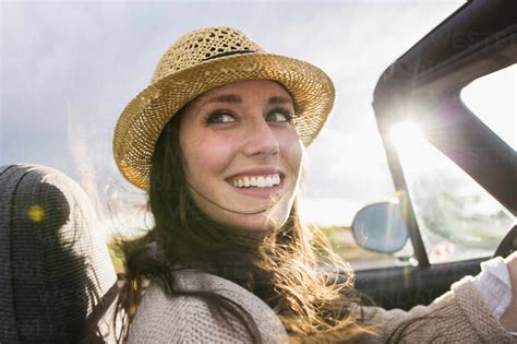 Caucasian woman driving convertible stock photo