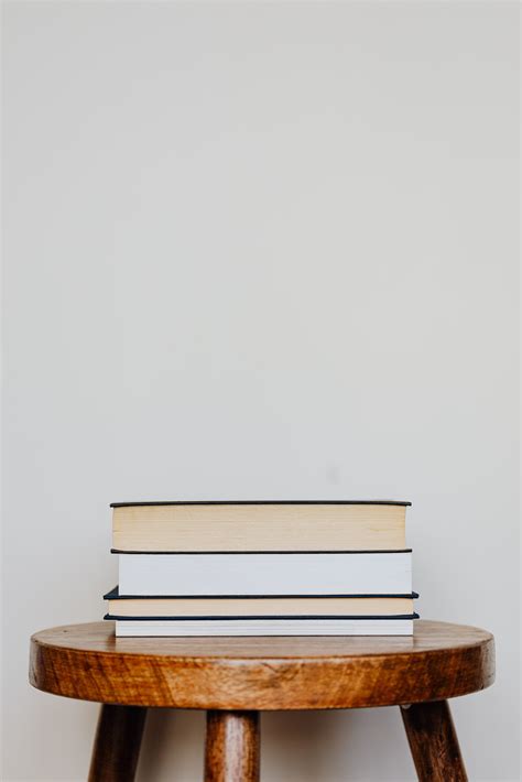 Pile of books accurately stacked on table · Free Stock Photo