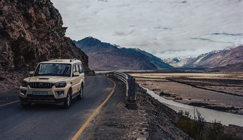 A Car on the Road in Mountains · Free Stock Photo